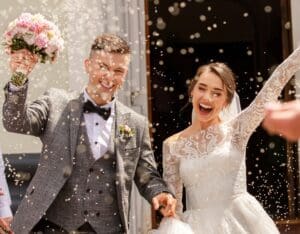 brudeparet kommer ut fra vielsen, og er overlykkelige. Det kastes ris på de.