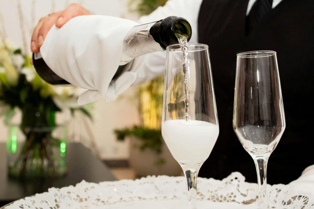 Bartender heller champagne i glass